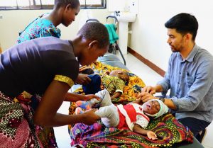 Dr. Ryan Examining Babies and Consulting with their Mothers